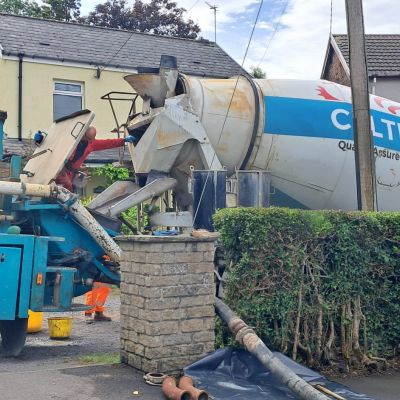 Concrete and concrete pump supplied with 60 mtr of pipeline to pour garage foundation at the bottom of the garden